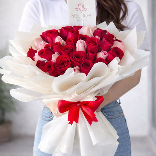 Ramo premium de rosas rojas y rosas blush con envoltura blanca elegante y moño rojo, envío local en Monterrey.
